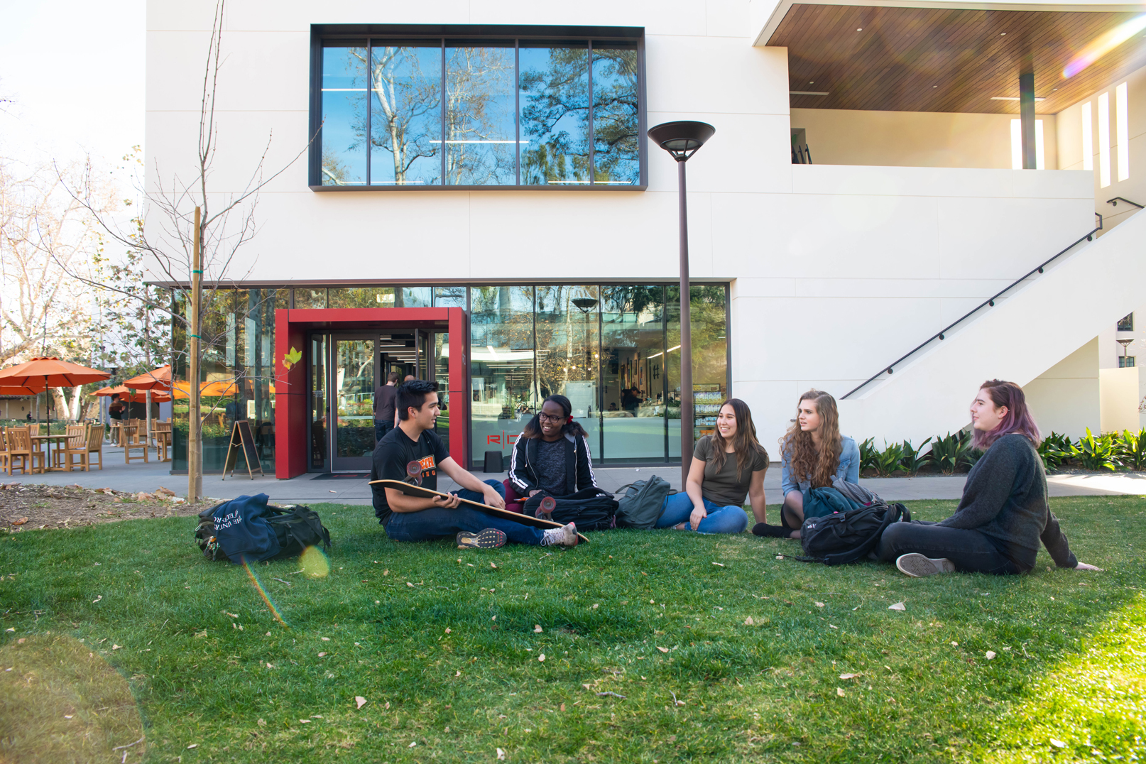 group of five students sitting on the campus lawn at The California Institute of Technology