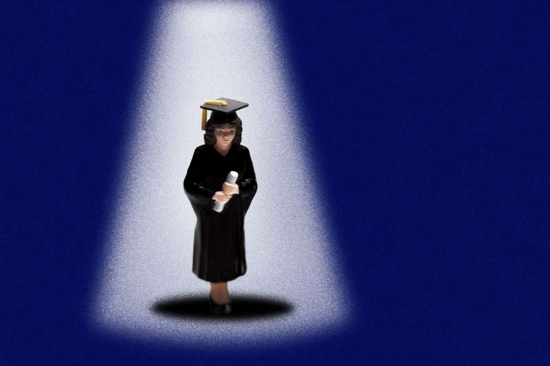Photo Illustration of a graduate student figure standing underneath a spotlight in an empty space