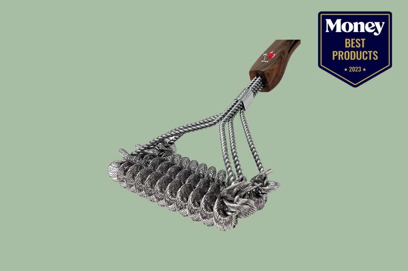 a grill brush with a stainless steel head of bristles and a wooden handle on a sage green backdrop