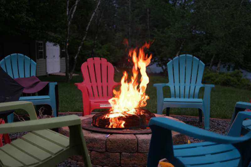 Firepit surrounded by empty chair