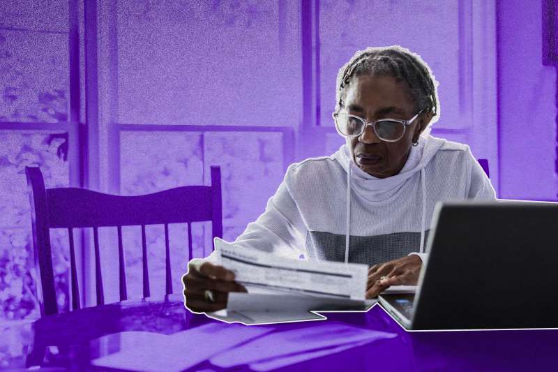 Older woman in her house, looking through paperwork