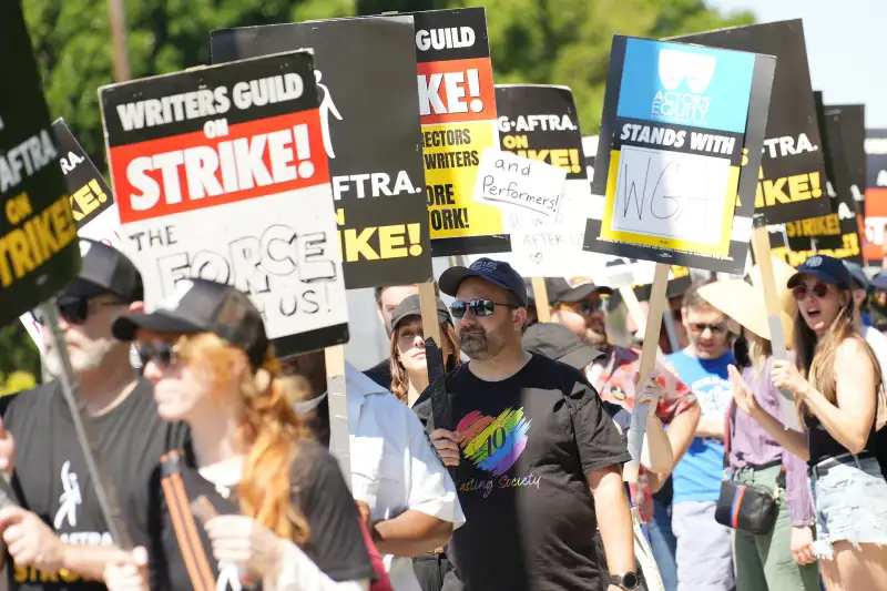 Members and supporters of SAG-AFTRA and WGA walk the picket line.