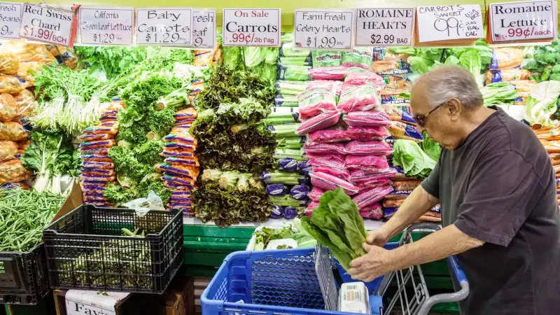 Man in a grocery store in the produce section