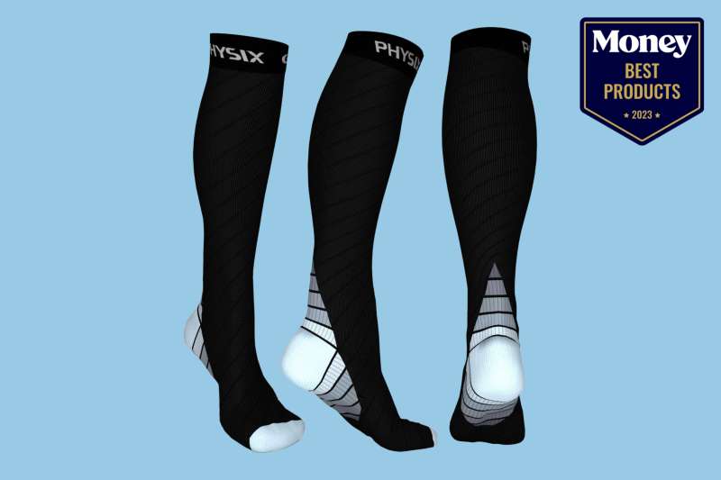 a woman's lower leg wearing one of the best compression sock brands in black on a light blue backdrop