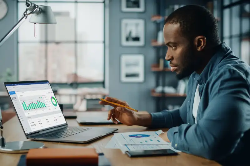 Man looking stocks on laptop