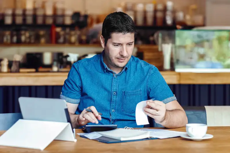 Small business owner looking over his finances