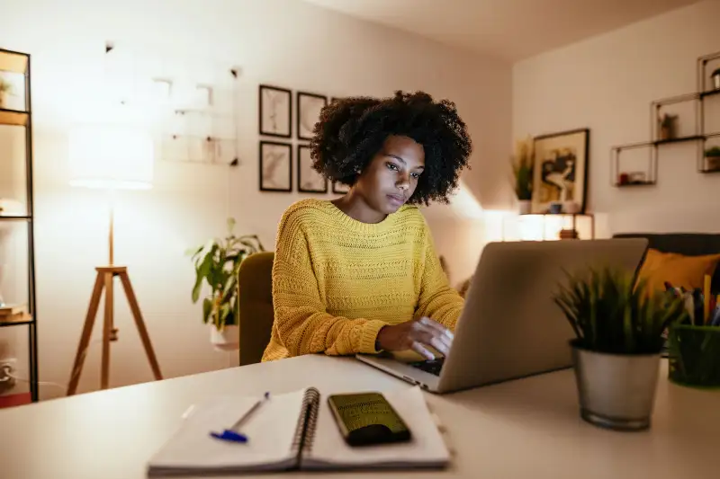 Woman used laptop in her house.