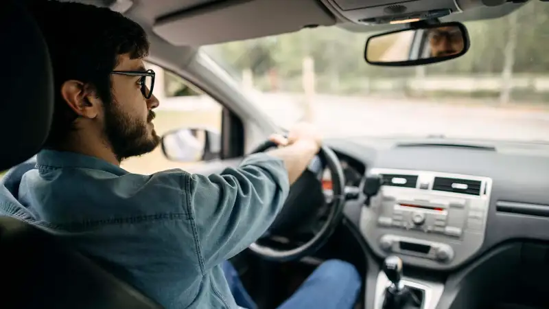 Young man driving a car