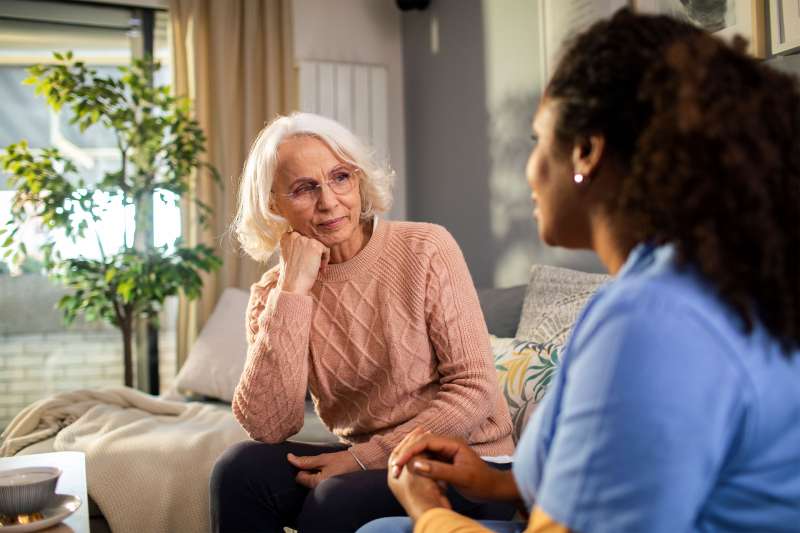 Older woman consults with nurse.