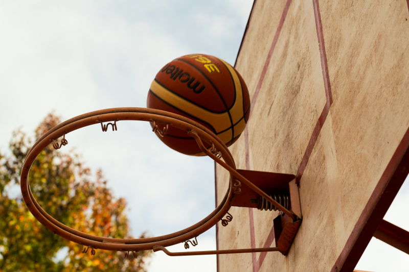 Brown Basketball Above Steel Basketball Hoop
