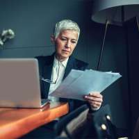 Woman looking over employer life insurance plan.