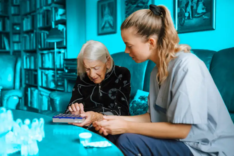 Senior woman talking with female caregiver over medicine box in living room