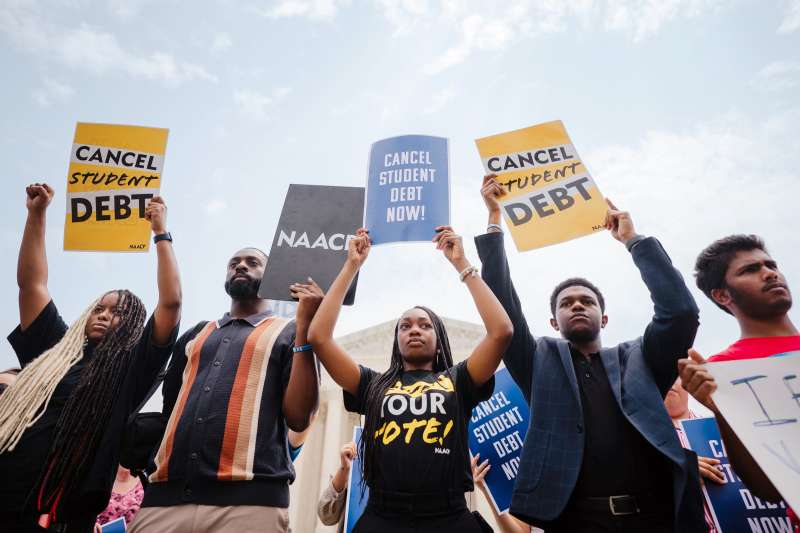 Student Loan Forgiveness Advocates rally outside of The Supreme Court of the United States with protest signs