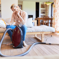 Cleaning Lady with Vacuum Cleaner and Vacuum Cleaner Bag