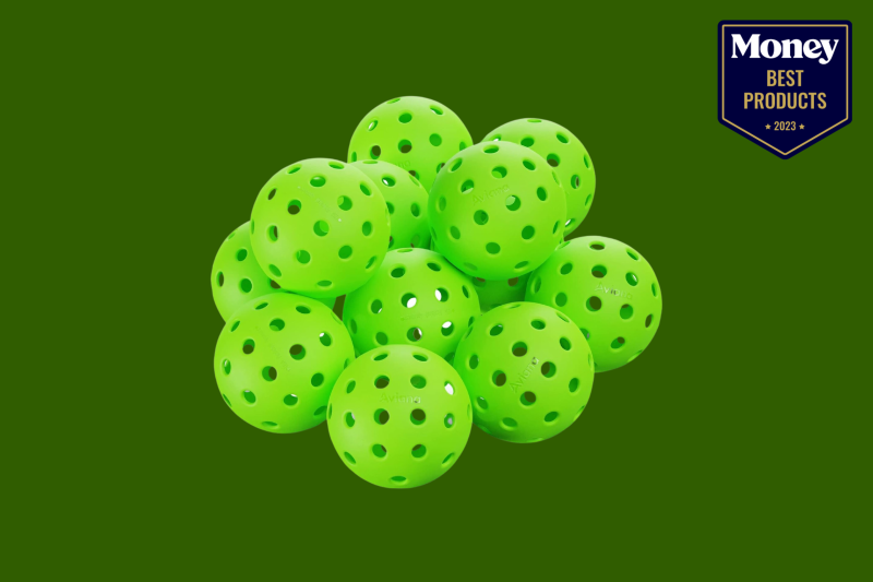 neon green pickleballs piled up on a hunter green backdrop