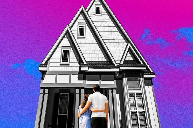 Couple standing in-front of a very tall, narrow house with a pink sky in the background