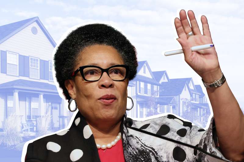 Portrait of Secretary of Housing and Urban Development Marcia Fudge with a picture of suburban houses in the background