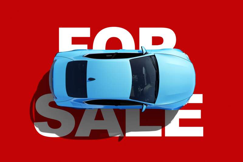 Photo Collage of an aerial view of a car laying on top of a giant  For Sale  sign