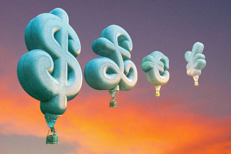 Photo-illustration of currency-shaped hot air balloons with a sunset in the background.