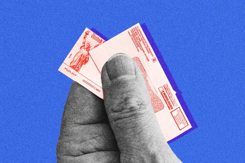 A hand holding a miniature social security check