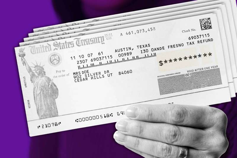 Close up of a hand holding a United States Treasury Check.