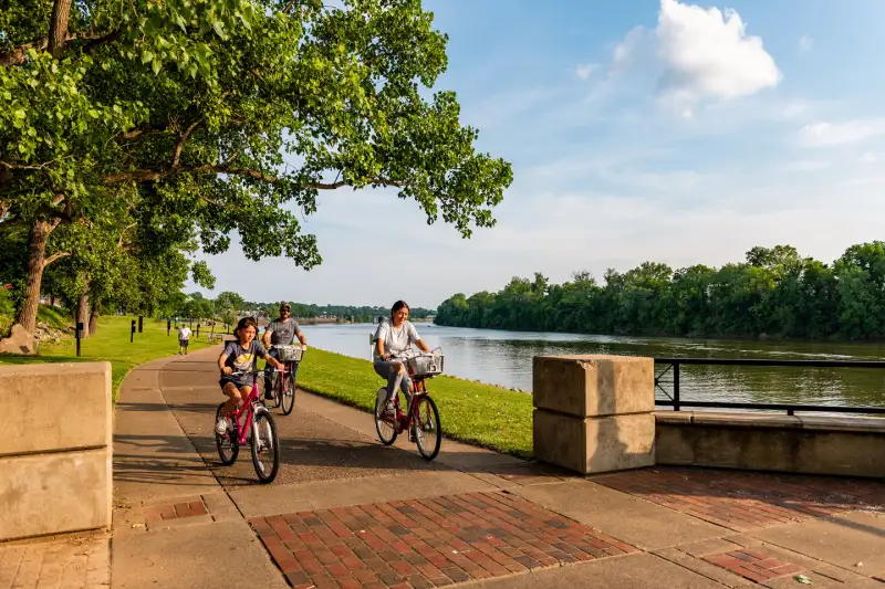 A family biking down the riverwalk in Clarksville