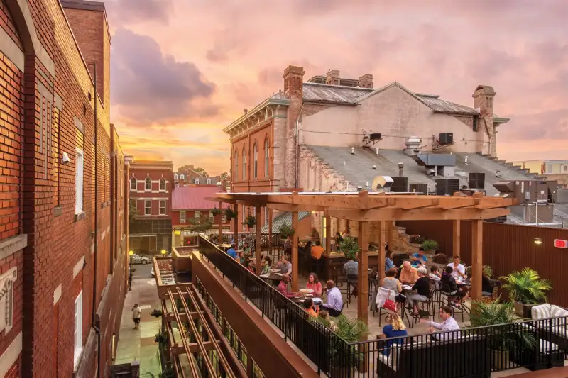 People sitting on an outdoor patio during sunset