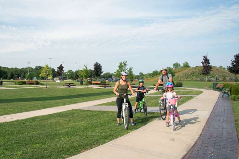 Family riding a bike in a park in Prairie Crossing