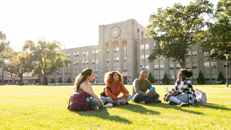 A photo of some college freshmen sitting on campus
