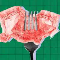 A hundred dollar bill speared onto a fork.